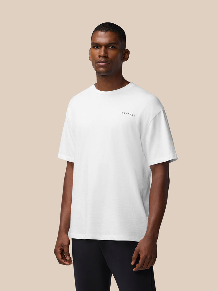 Male model wearing a white Flex Cotton T Shirt with a round neckline and small CASTORE logo on the chest.