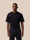Male model wearing black FLEX Cotton T Shirt with short sleeves and small chest logo
