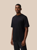 Black FLEX Cotton T Shirt on male model with relaxed fit and chest logo