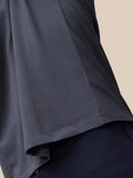 Close up of the lower side of the pewter Castore T shirt showing fabric drape and hem seam.