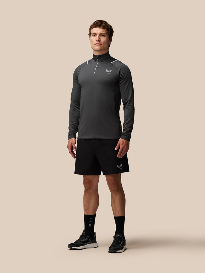 Back view of a male model wearing charcoal Apex Training Winterised 1/4 Zip Top highlighting back seam and high collar