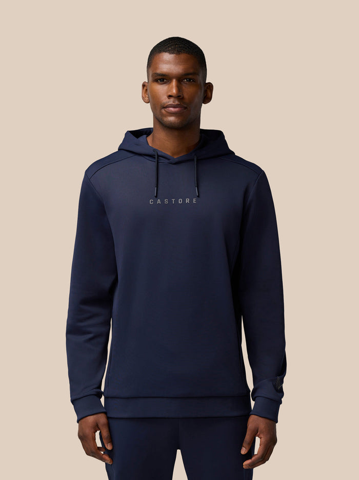 Front view of a man in navy Flex Thermo Hoodie with drawstrings and Castore branding on chest
