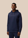 Front view of a man wearing navy Flex Thermo Hoodie with hood down and Castore logos on chest