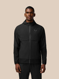 Male model wearing black Flex Winterised Woven Jacket with hood and front zip, Castore logo on left chest