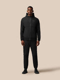 Male model wearing black Flex Winterised woven jacket with hood, front zip and zip pockets, Castore logo on left chest