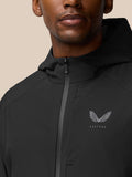 Close-up of black hooded Flex Winterised woven jacket showing zipper and Castore logo on chest