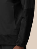Black jacket chest area with vertical zipper and Castore emblem on left chest