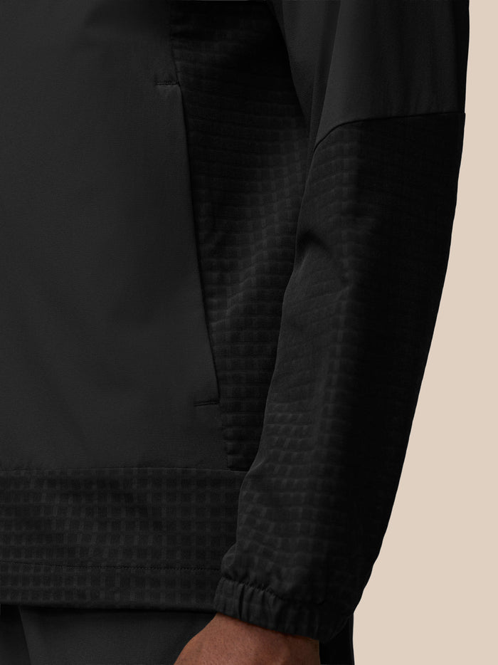 Black jacket chest area with vertical zipper and Castore emblem on left chest