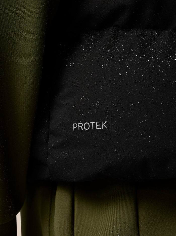Water droplets on black ProTek fabric with olive green panel visible