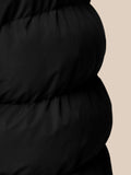 Close-up of black puffer gilet fabric showing quilted panels and texture