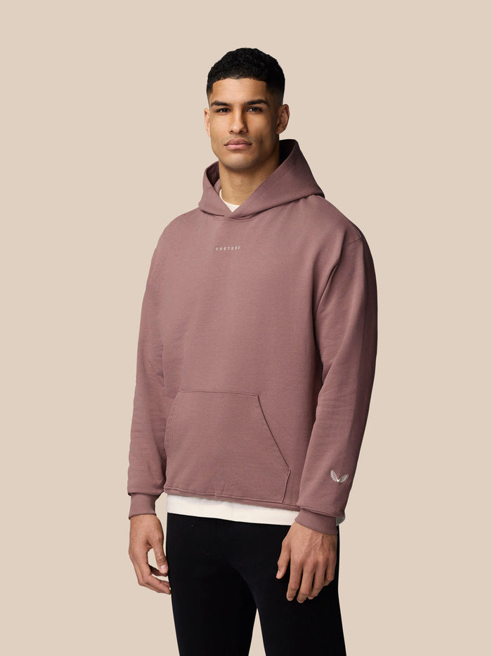 Male model wearing mauve ADAPT LIFESTYLE HOODIE with hood up and front pocket