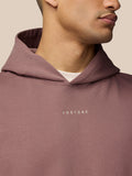 Close-up of the mauve Adapt Lifestyle Hoodie with hood up and Castore embroidery on the chest.