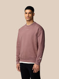 Front view of a male model wearing mauve ADAPT lifestyle sweatshirt with a small logo on the chest.