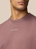 Close-up of the chest area showing the small white Castore logo on the mauve sweatshirt