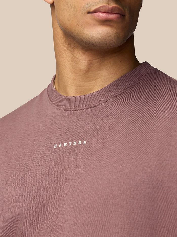 Close-up of the chest area showing the small white Castore logo on the mauve sweatshirt