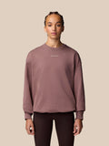 Female model wearing mauve ADAPT LIFESTYLE SWEATSHIRT with oversized silhouette and crew neckline