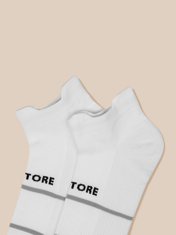 White athletic socks with grey stripes and Castore branding at the cuff