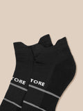 Close-up of black athletic socks with cushioned sole and seamless toe Castore branding visible
