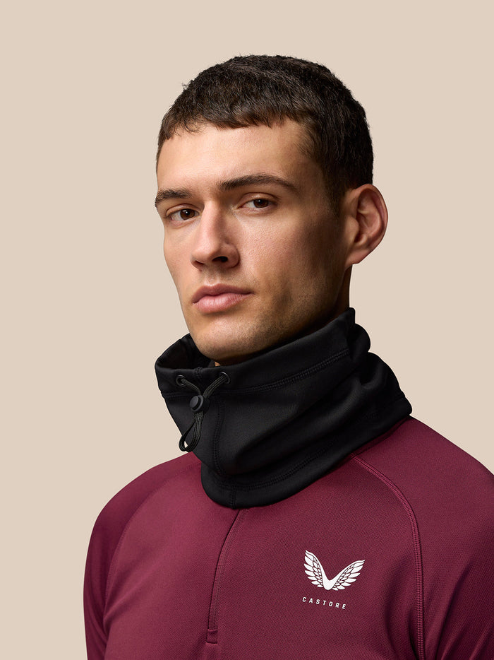 Unisex Core Snood in black worn around the neck by a male model during training