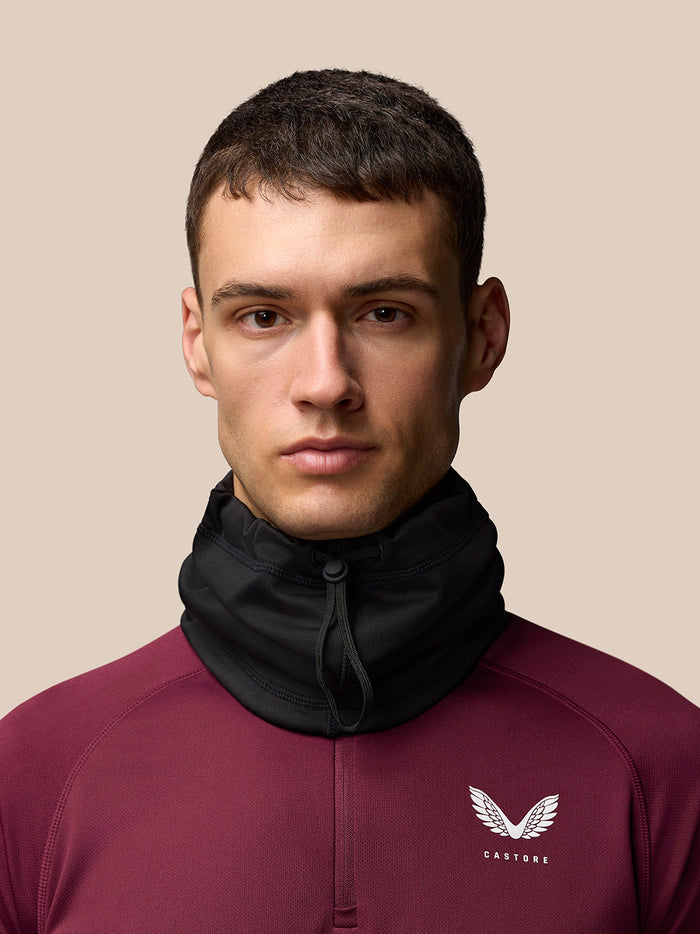 Black Core Snood worn high around the neck for warmth on a model