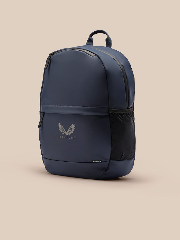 Navy compact backpack with padded back top handle side mesh pocket and Castore logo on front