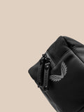 Close up of a black Active Wash Bag showing rugged zipper pulls and durable fabric with a wing logo.