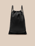 Close up of the top of the black gym sack showing the gathered opening and double drawstrings.