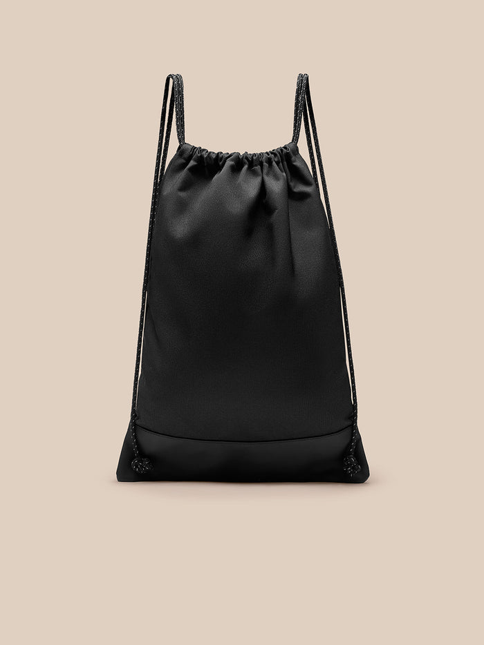 Close up of the top of the black gym sack showing the gathered opening and double drawstrings.