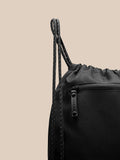 Close up of the front zipper pocket and corded edge on the black gym sack.