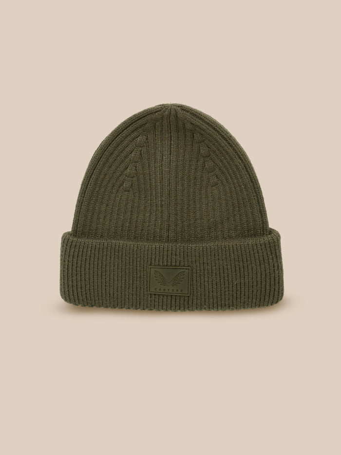 Ivy green ribbed knit beanie with foldover and Castore logo patch viewed from the front