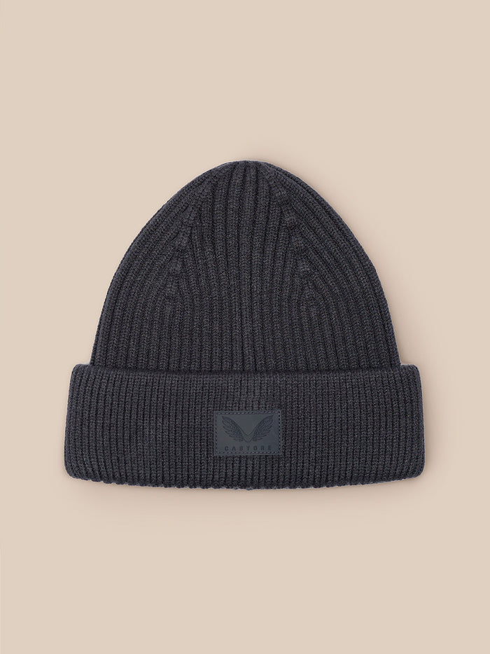 Folded dark grey ribbed beanie with Castore logo patch on the front cuff.