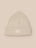Stone ribbed knit beanie with folded brim and Castore logo patch visible