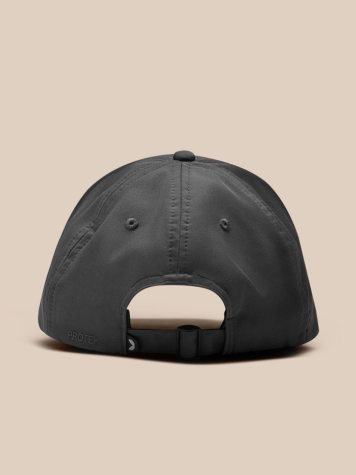Back view of gunmetal nylon cap with adjustable strap and PROTEK branding.