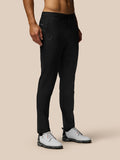 Black golf trousers shown on a model with belt loops side pockets and branding on the thigh and rear