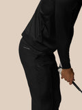 Close up of black golf trousers showing CASTORE branding on the pocket and neat stitching