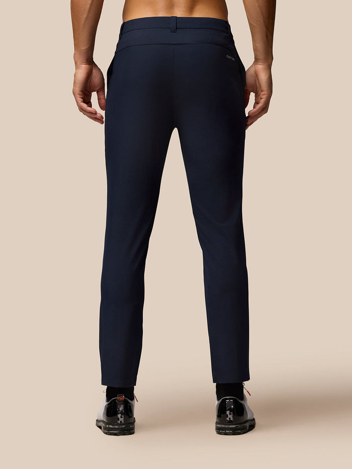 Back view of midnight navy golf trousers on a model highlighting rear branding.