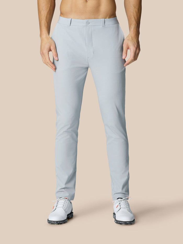 Front view of a man in light grey Golf Club Trousers paired with white golf shoes.