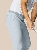 Back view of light grey golf trousers with a woven belt and Castore branding on the pocket.