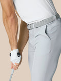 Side view of a model wearing light grey ProTek golf trousers with a braided belt.