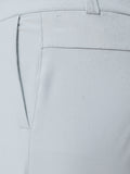 Close-up of light grey golf trousers showing ProTek branding on the back pocket with water droplets.