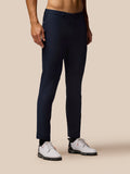 Midnight navy golf club trousers worn by a model front view with Castore branding on the pocket