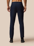 Back view of midnight navy golf club trousers on a model with Castore branding on the back pocket