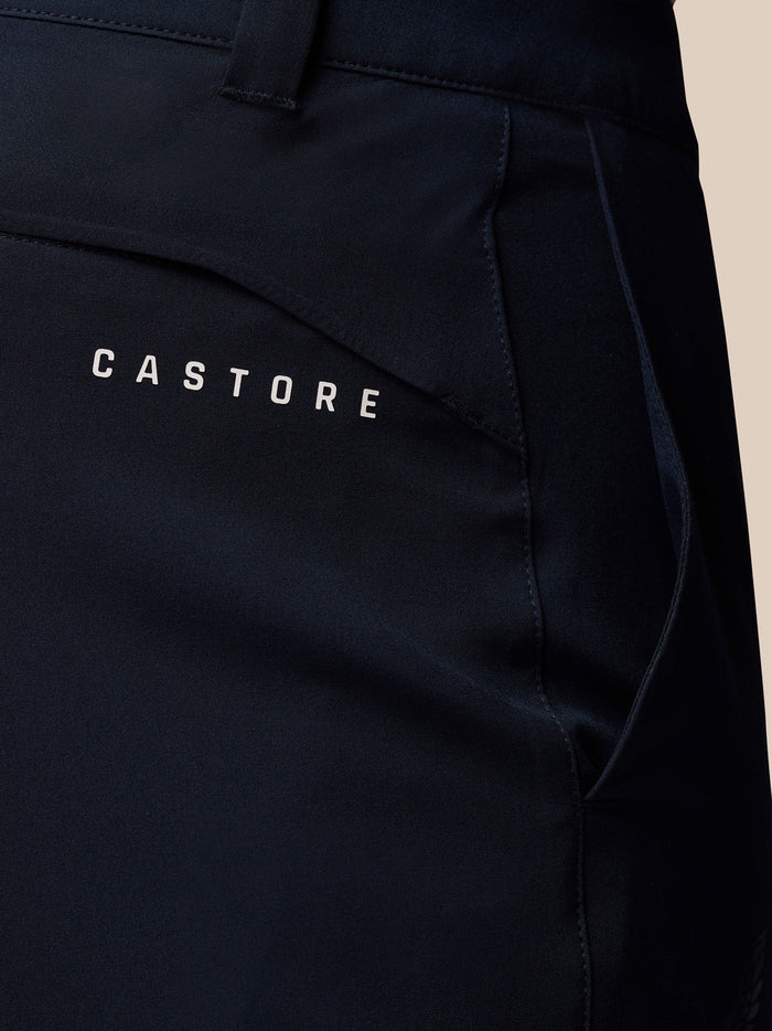 Close up of dark navy golf trouser fabric with Castore branding on the pocket area.