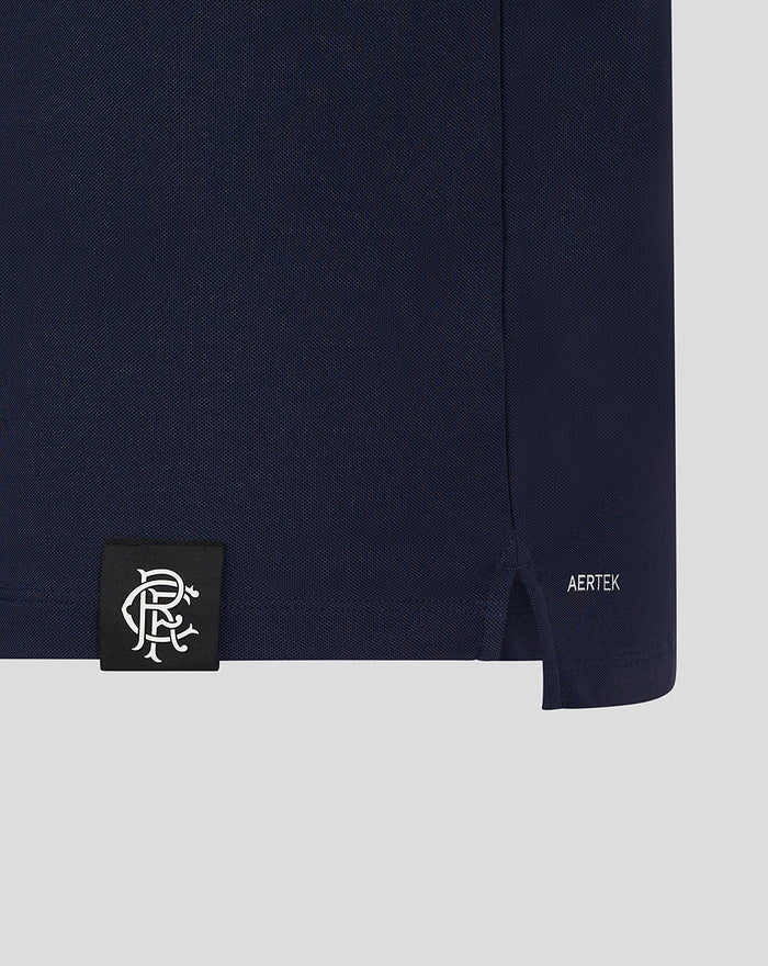 Detail of navy polo hem with side vent and AERTEK logo