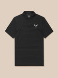 Male model wearing black Pinnacle Pique Stripe Polo with stripe texture and white Castore chest logo.