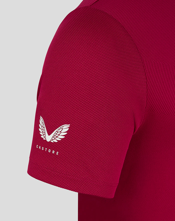 Detail of magenta polo sleeve with white crest and visible knit pattern