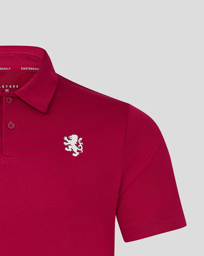 Close-up of magenta Pinnacle polo showing the white crest on the left chest and knit texture near the shoulder