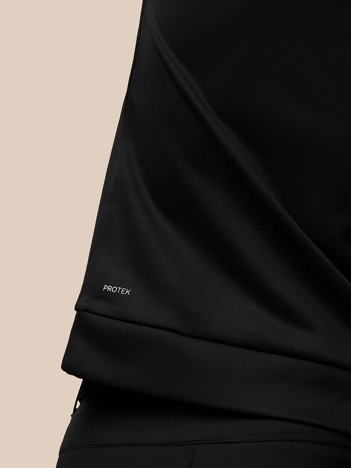 Close up of the sleeve showing Protek branding on the black Golf Club Classic top