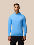 Front view of man wearing light blue Golf Club Classic quarter zip top with funnel collar and Castore logo on left chest