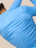 Back view of the blue Castore top showing the Castore logo on the upper back